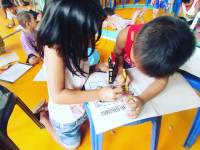 Children busy coloring the drawing