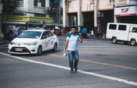 Street photography, young man crossing the street