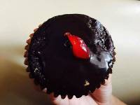 chocolate cupcake, red icing on top
