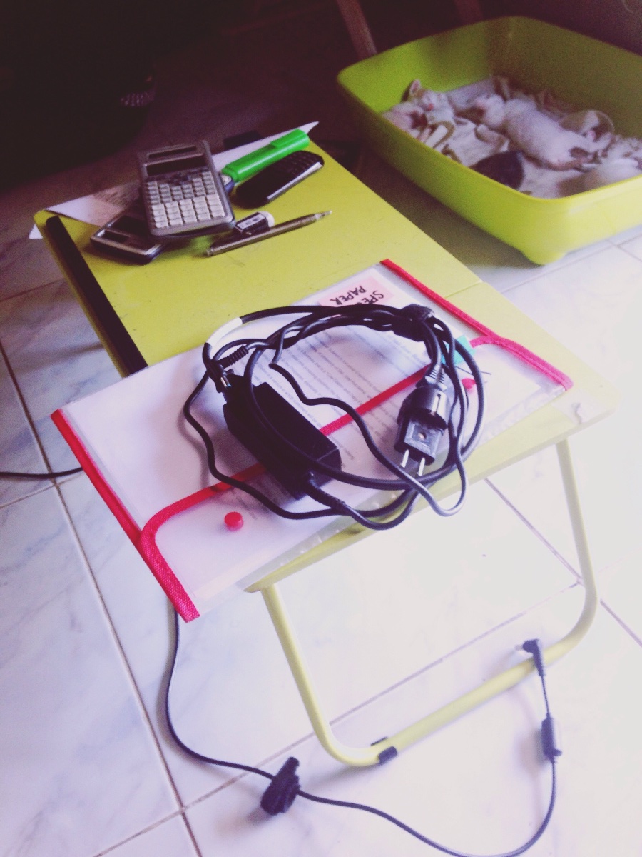 Yellow green table laptop black charger calculators school things