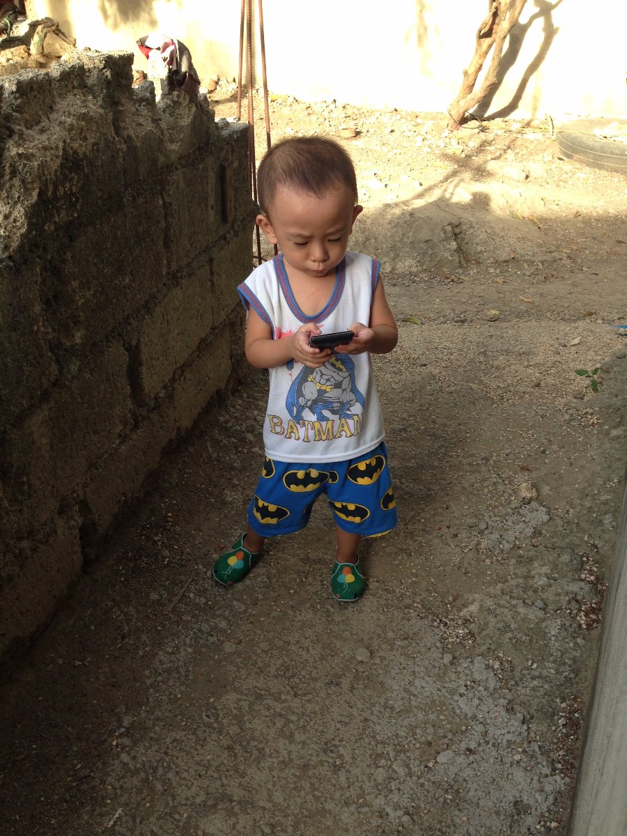 baby gaven, busy texting, batman shirt and shorts