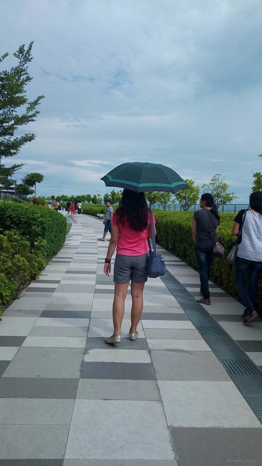 back view girl in pink with an umbrella