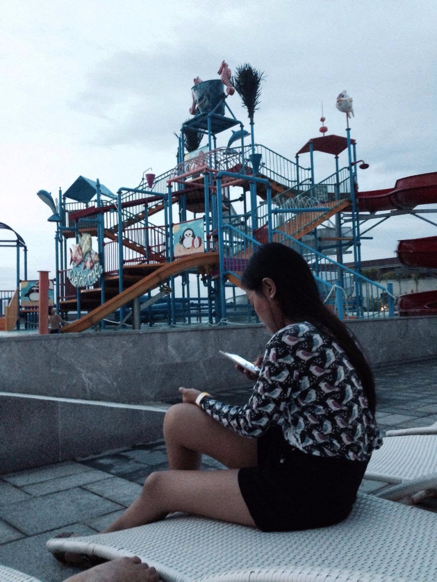 girl, sitting, busy, texting, at sky water park