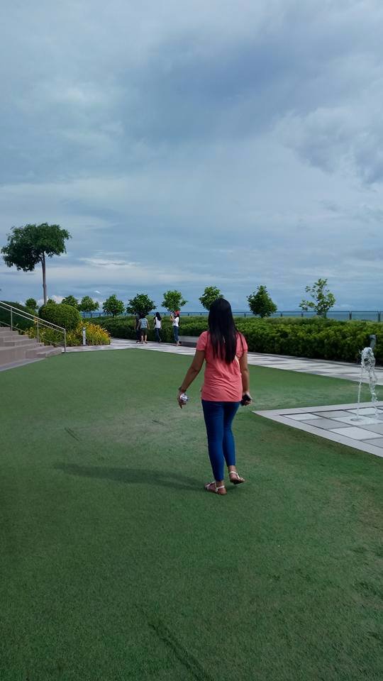 strolling around sky park back view peach shirt ft blue jeans