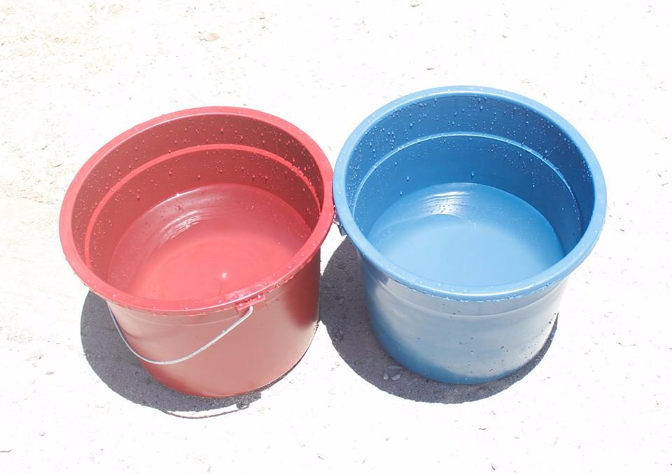 two pale of water blue and red with water inside