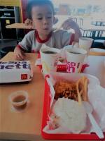 baby gaven enjoying his meal, eating McDo