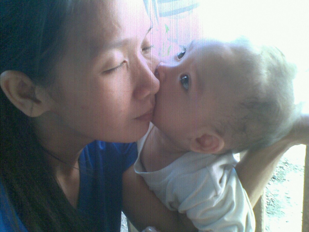 a kiss from a son to his mother he just love to kiss me