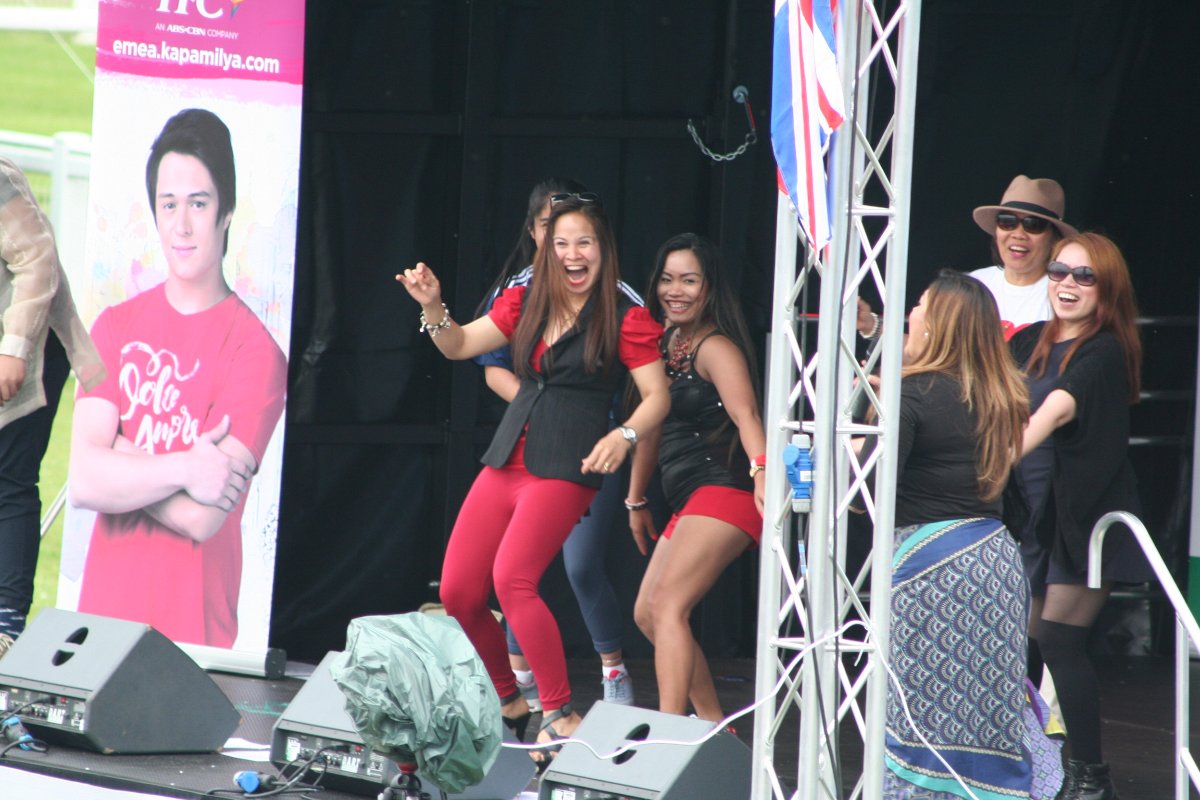 Having fun on stage ladies Doing a bit of grinding for the entertainment of everyone, Yorkshire Barrio Fiesta, Ripon, UK, 2016