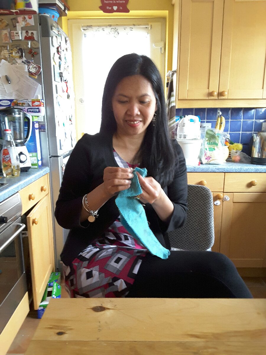 polishing her jewellery, special polishing cloth, looks happy