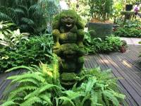 funny looking statue, orchids