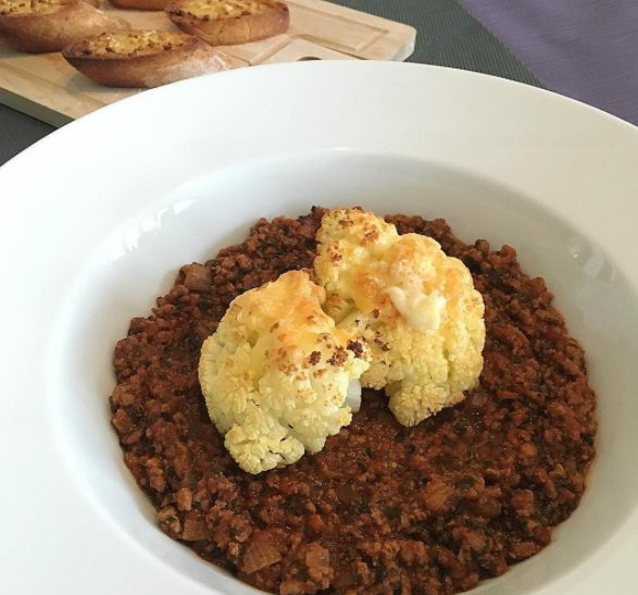 baked and flamed cauliflower with mozzarella and emmental cheese on a bed of tomato and spinach meat sauce with garlic bread for dipping. . . of course I eat meat, lots of it
